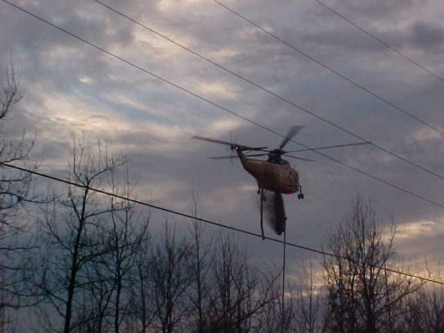 Fire fighting helicopter delivering its watery payload to the drop zone.